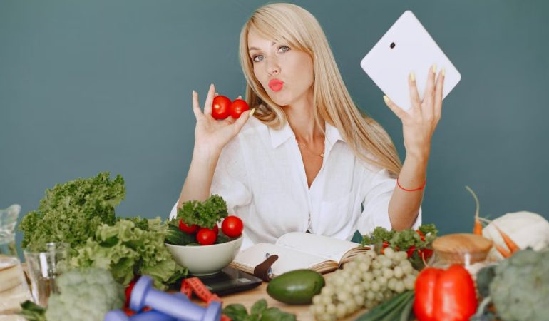 Vlogger promoting healthy eating with fresh vegetables on the table.